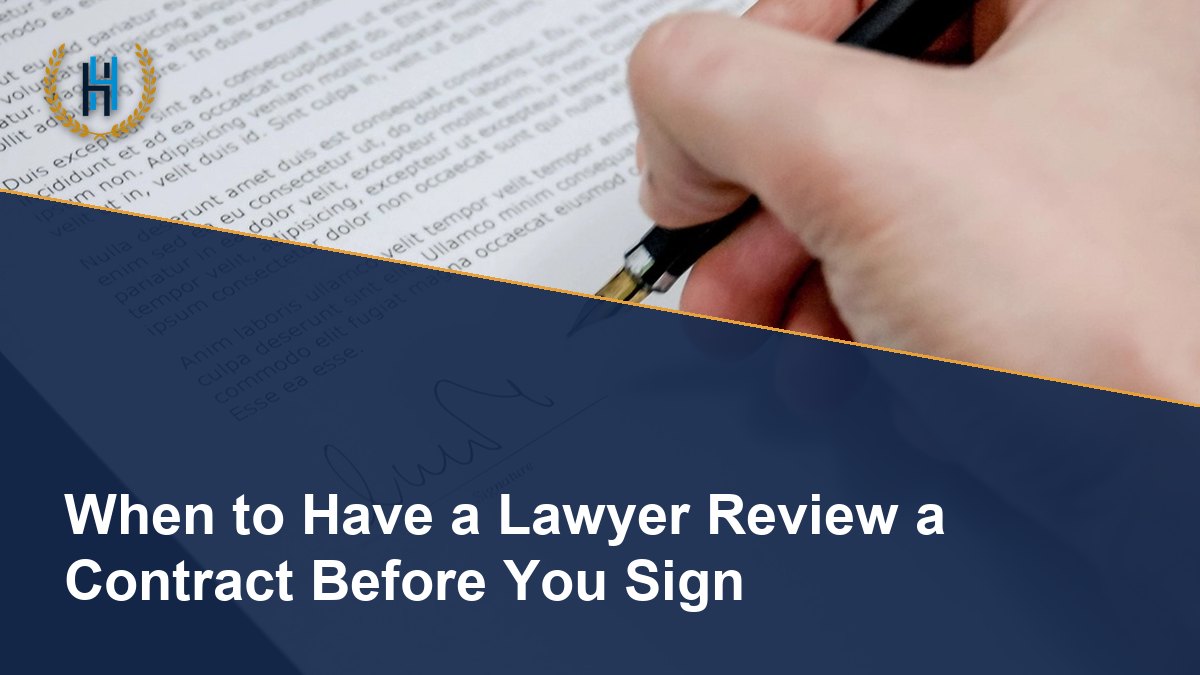 Hand using a fountain pen to sign a contract on a signature line
